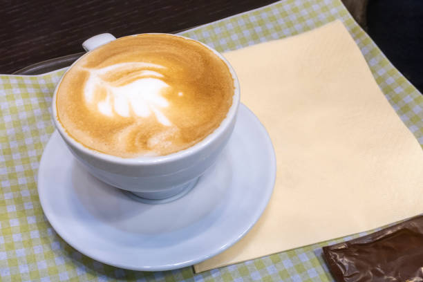 istock Cappuccino cup with foam art on tray with napkins. White cup. 1214501486
