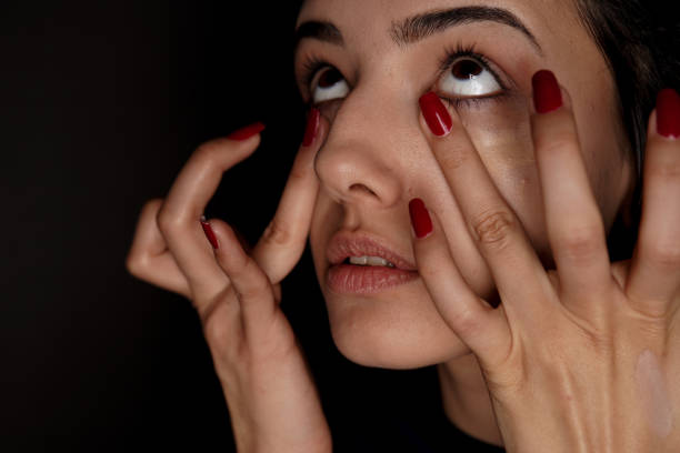 istock young woman applying concealer to her face 1214501613