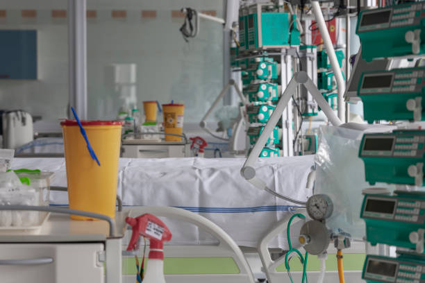istock Intensive care unit in hospital, beds with infusion pumps,  ventilators, a place where can be  treated patients with pneumonia caused by coronavirus covid 19. 1214501819