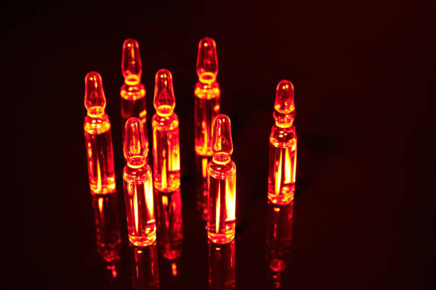 istock Vaccine against a virus on a black background. 1214503107