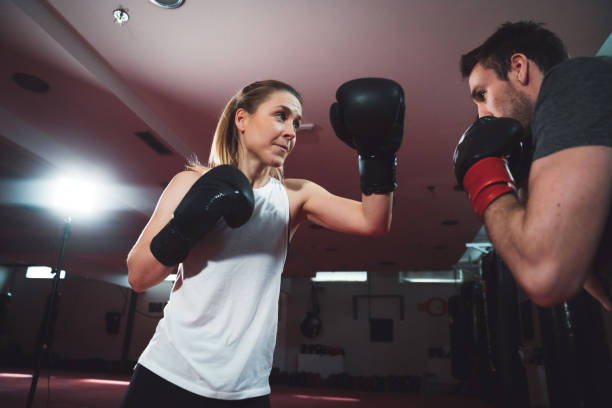 istock Woman boxing with her male partner 1214504186