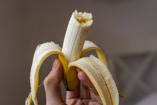 istock Half peeled ripe banana 1214504880