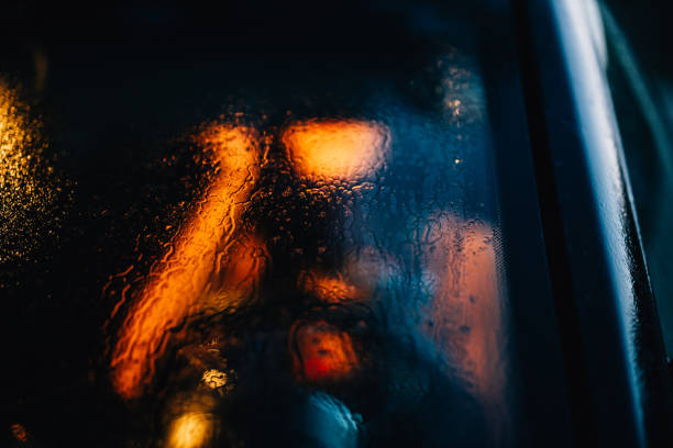 istock Person unfocused through the window car with drops 1214506510