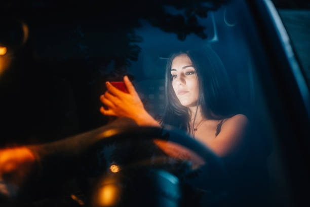 istock Young woman inside a car using her smartphone 1214506511