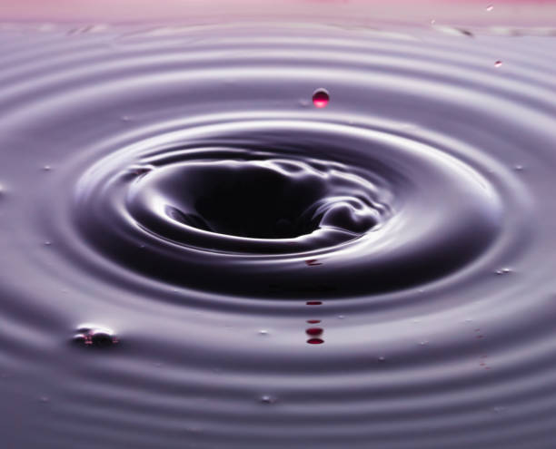 istock rippling after a few drops of Red wine. 1214508018
