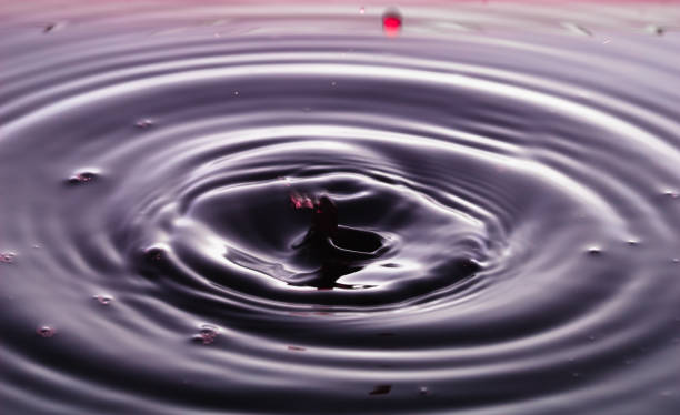 istock rippling after a few drops of Red wine. 1214508019