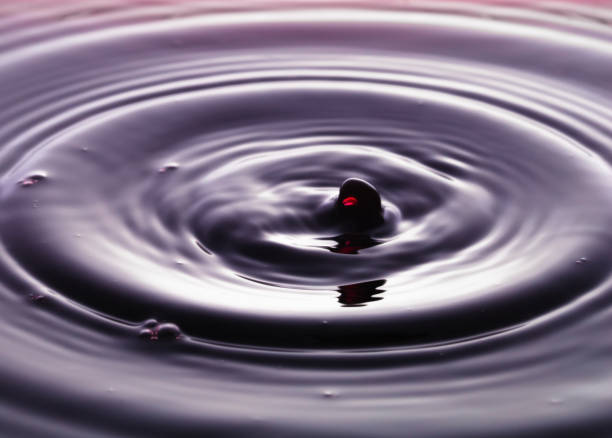 istock rippling after a few drops of Red wine. 1214508052