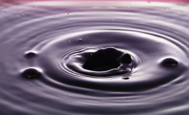 istock rippling after a few drops of Red wine. 1214508073