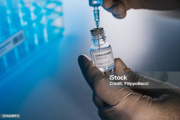 Doctor Preparing The Coronavirus Covid19 Vaccine Stock Photo - Download Image Now - Vaccination, COVID-19 Vaccine, Injecting