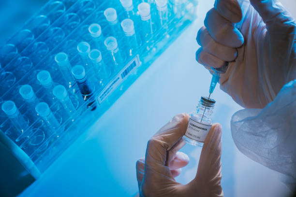 Doctor preparing the coronavirus COVID-19 vaccine Doctor preparing the coronavirus COVID-19 vaccine. Details of hands and syringe. research foundation stock pictures, royalty-free photos & images