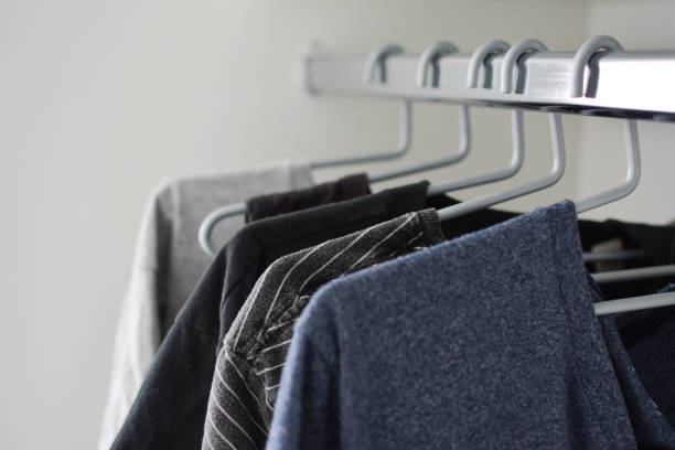 istock Clean clothes hanging on a clothing rack, home closet 1214510775