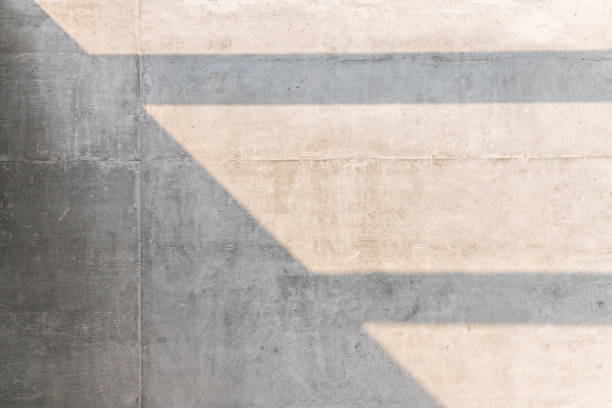 istock The morning sunlight casting abstract shadow over the gray concrete wall texture, sunshade shadow background. 1214512599