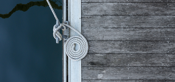 Mooring bollard with cord  on a wooden pier