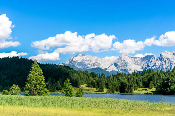 istock beautiful blue natural lake with mountains in the background 1214516537