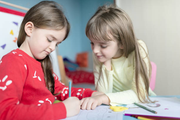 istock Sisters drawing and playing together in their bedroom 1214517212