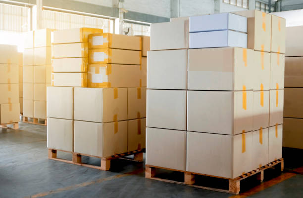 istock Interior of warehouse with stack package boxes on pallets, Warehouse industry delivery shipment goods, Logistics and transport 1214517389