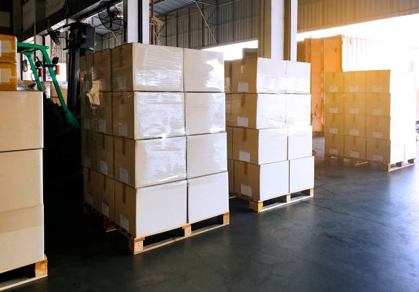 istock Interior of warehouse with stack package boxes on pallets, Warehouse industry delivery shipment goods, Logistics and transport 1214517432