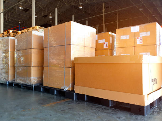 istock Interior of warehouse with stack package boxes on pallets, Warehouse industry delivery shipment goods, Logistics and transport 1214517440