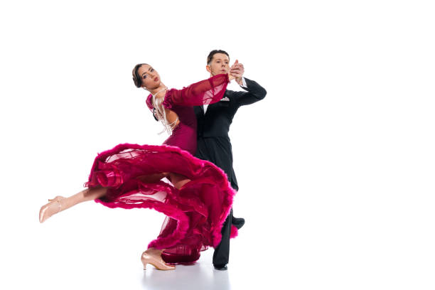 elegant young couple of ballroom dancers in red dress in suit dancing on white - tangoing imagens e fotografias de stock