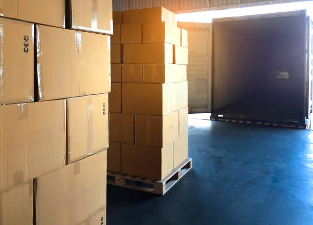 istock Stack cardboard boxes on wooden pallets at distribution warehouse, the truck container docking load cargo shipment, freight industry warehouse, logistics and transport. 1214518801