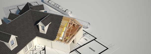 istock Unfinished house on top of blueprints 1214520117
