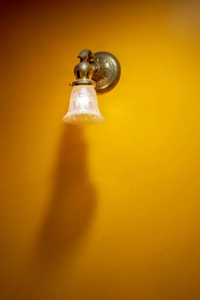 Photo of Illuminated lamp on interior wall