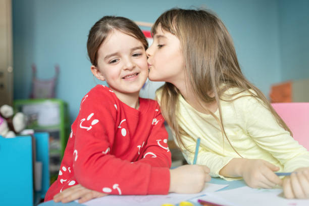 istock Sisters drawing and playing together in their bedroom 1214520853