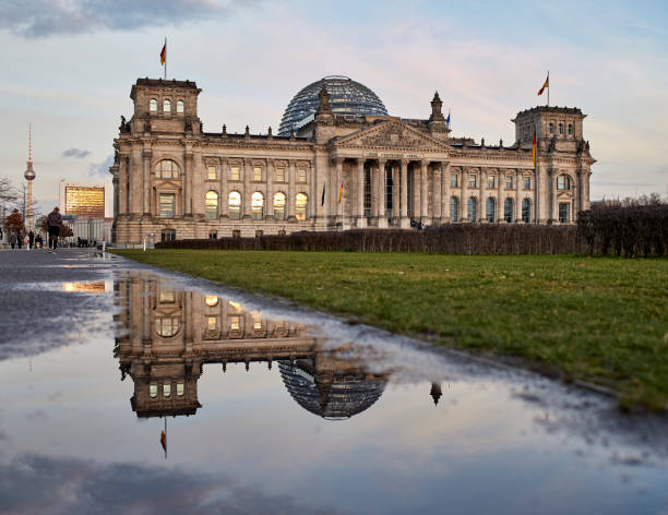 istock The Reichstag building during sunset in Berlin, Germany with reflection 1214521936