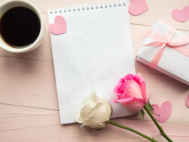 istock Love composition - coffee cup, gift box and roses on pink background, top view. Valentines Day greeting card 1214522217