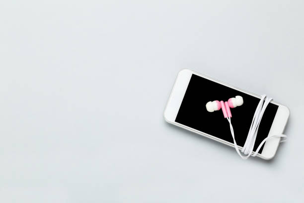 istock Earphones with mobile phone on gray background 1214522463