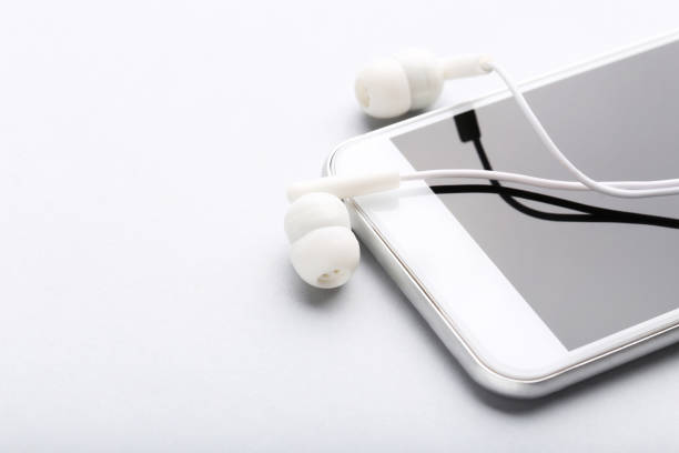istock Earphones with mobile phone on gray background 1214522835