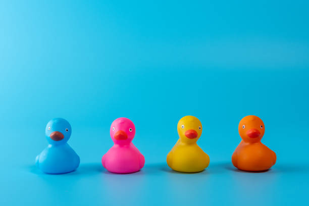 istock Colorful rubber ducks on blue background. Summer minimal concept. 1214525993