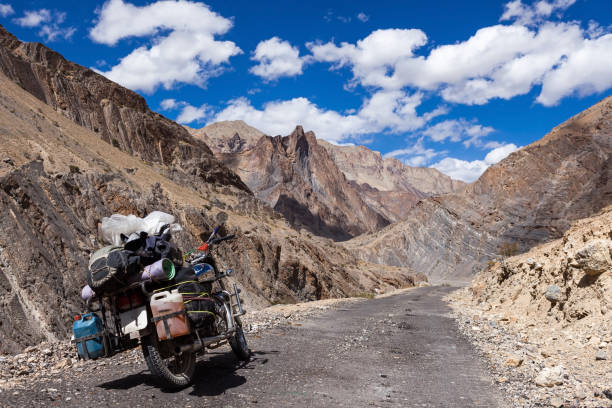 Bike travelling in Zanskar Valley, Indya. Bike travelling in Zanskar Valley, Indya. Travel by motorcycle in Ladakh, North India. Fully loaded touring bike on the road in Zanskar. jammu and kashmir photos stock pictures, royalty-free photos & images