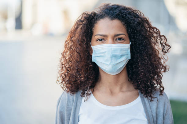 istock Woman with face protective mask 1214527744