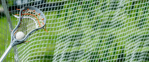 istock Abstract view of a lacrosse stick scooping up a ball 1214528634