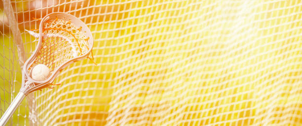 istock Abstract view of a lacrosse stick scooping up a ball 1214529575
