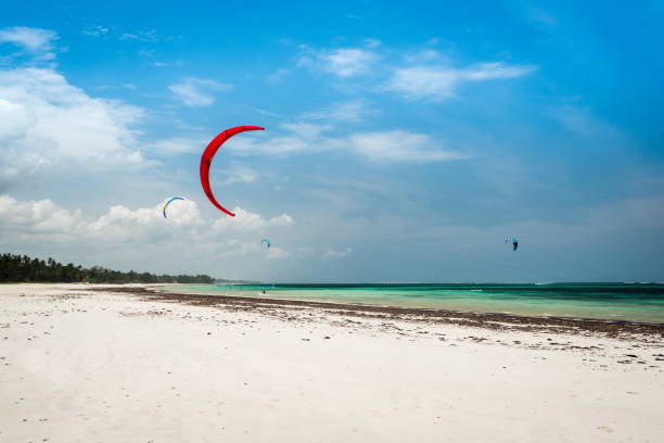kite location in Africa, kitesurfing spot in Diani , Gallu beach Kenya and Kendwa Zanzibar. Beautiful kiteboarding school with white sand and crystal sea water. Kite in the air on the kite beach Lerning kitesurfing in Kenya and Zanzibar. Kite in the air landscape from Diani Beach Kendwa Watamu kite sailing stock pictures, royalty-free photos & images