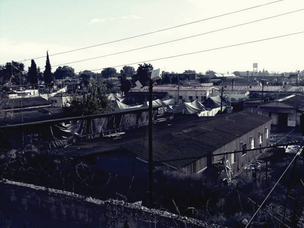 A view of an old and abandoned prison base. It also looks like a factory area. Dark mood concept.