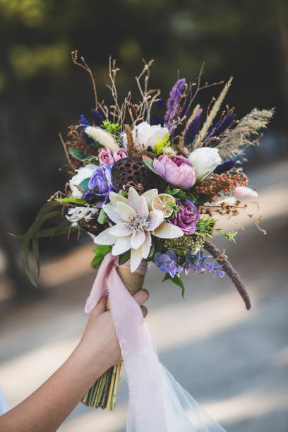 istock The bride and the flowers in her hand 1214532625