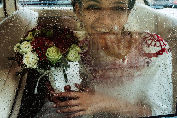 istock stylish brunette bride smiling and having fun in retro car, wedding ceremony 1214533610