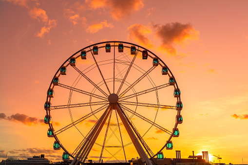 This pic shows Ferris Wheel  at evening time before Sunset . colorful sunset sky in background of wheel can be seen in the pic. The pic is taken in helsinki finland in august 2019.