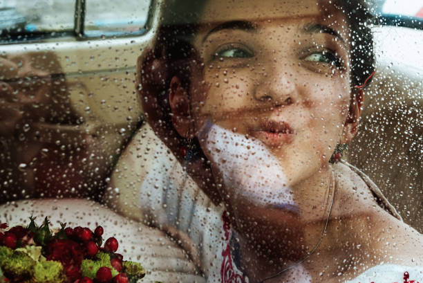 istock stylish brunette bride smiling and having fun in retro car, wedding ceremony 1214535224