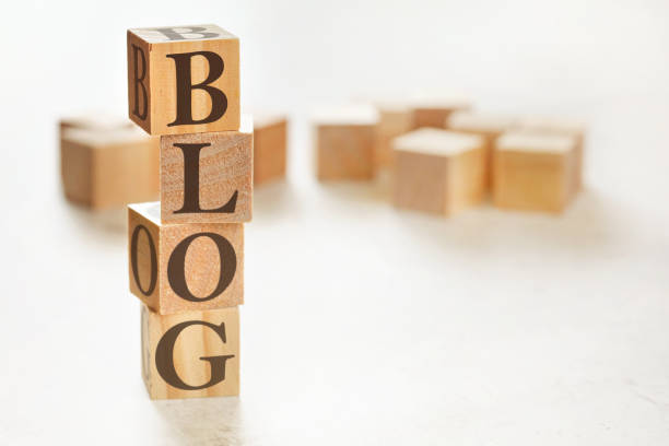 istock Four wooden cubes arranged in stack with word BLOG on them, space for text / image at down right corner 1214535260