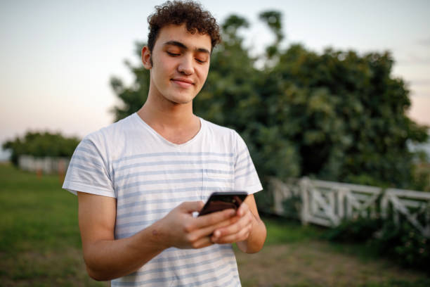 istock Teenager boy texting message 1214535831