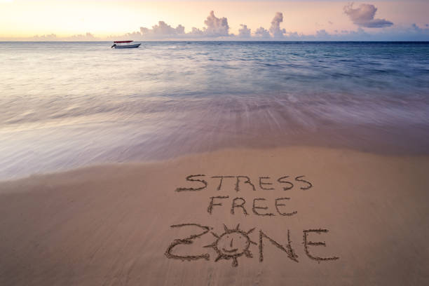 istock handwritten Stress free zone on sandy beach 1214537328