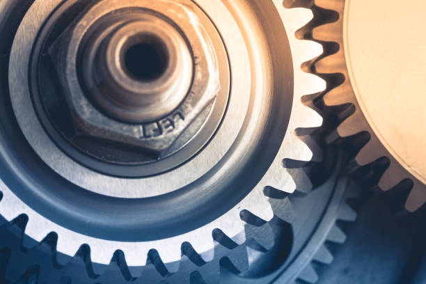 istock gears industrial background with warm shiny light 1214537530
