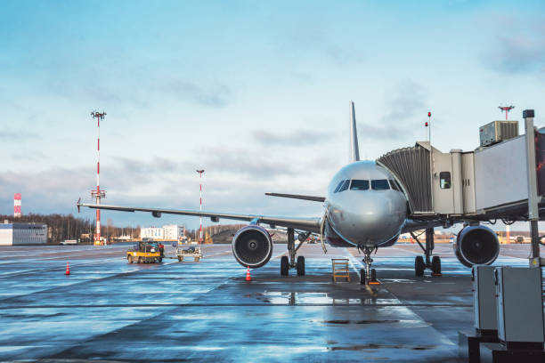 istock Passenger aircraft with boarding stairs, waiting for boarding passengers and baggage before the flight airport trip. 1214537612