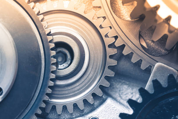 istock gears industrial background with warm shiny light 1214537864