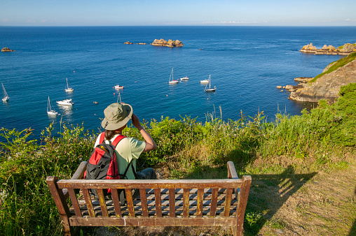 young womanat scenic view point on Sark Island, Guernsey, Channel Islands, UK
