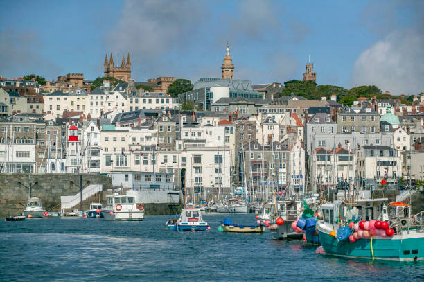 St.Peter Port on Guernsey Island, Channel Islands, UK Harbor and cityscape of St.Peter Port on Guernsey Island, Channel Islands, UK guernsey city stock pictures, royalty-free photos & images
